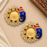 Pair of decorative earrings with colorful design on a beige fabric background