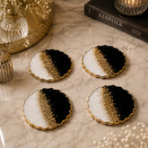 Black and white resin coaster set with gold flakes and glossy finish for luxury table décor.
