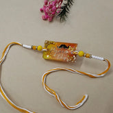Decorative rakhi with text and beads on a beige background