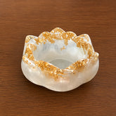 Decorative White & Gold Resin Diya Holder on a wooden surface