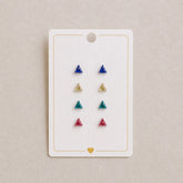 Set of triangle-shaped earrings on a display card with a beige background