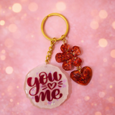 Handcrafted pink resin keychain with you and me text and red heart