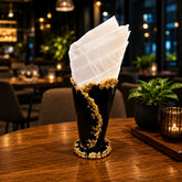 Decorative glass with gold rim on a wooden table in a restaurant setting