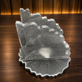 Clear glass napkin holder on a wooden surface