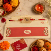 Rakhi with a card and traditional items on a decorative setting