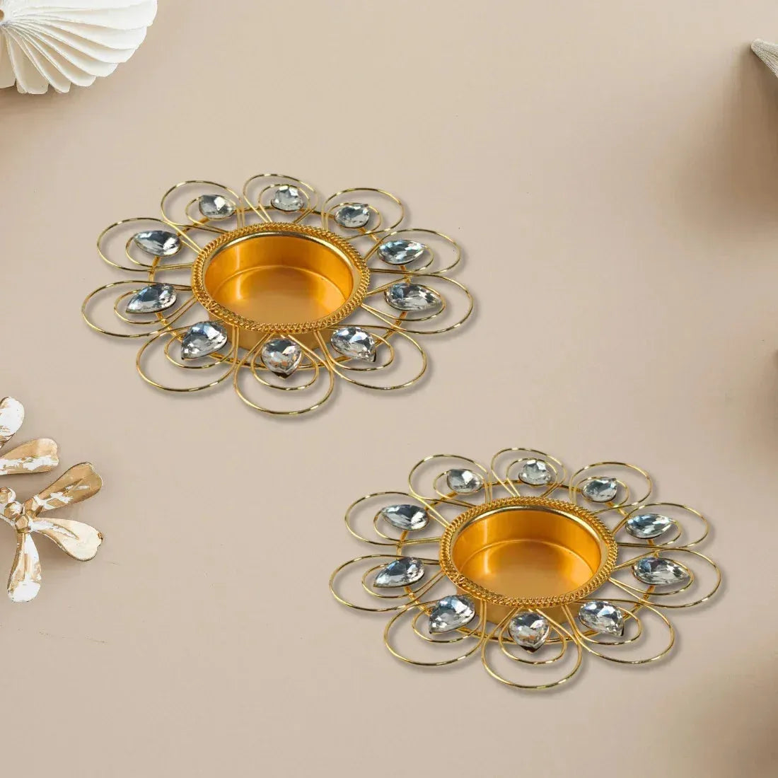Two decorative metal trays with gold and silver design on a beige background