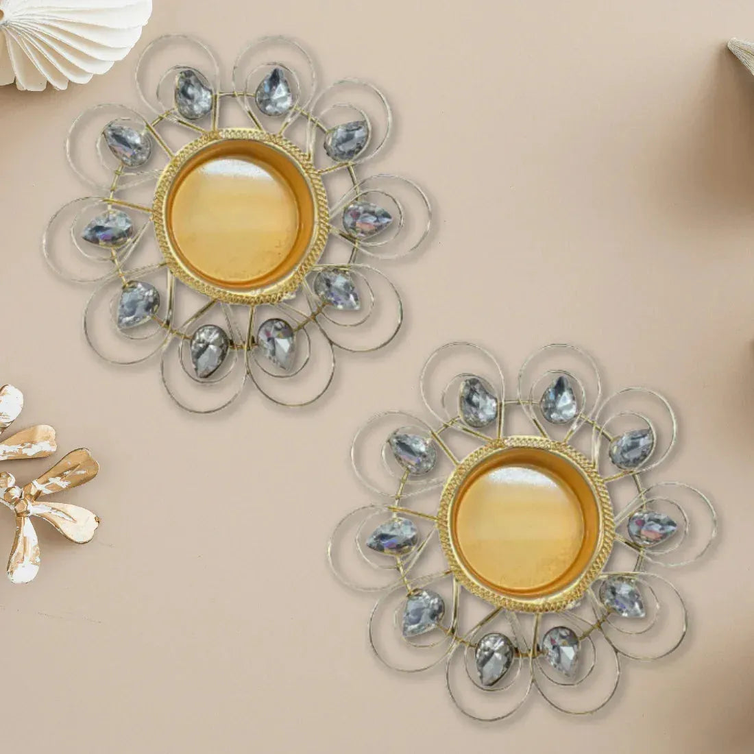 Decorative wall mirrors with floral designs and gemstone-like accents on a beige background.