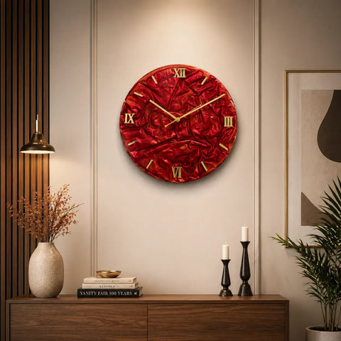 Red wall clock with gold accents on a wall in a room with decor elements.