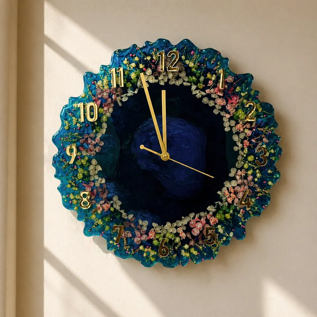 Decorative wall clock with floral design and blue center on a beige wall.