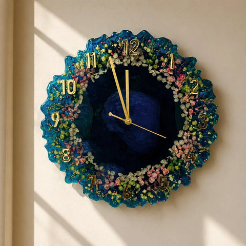 Decorative wall clock with floral design and blue center on a beige wall.