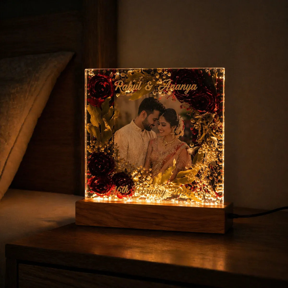Personalized light box with a couple's photo and names on a wooden base.