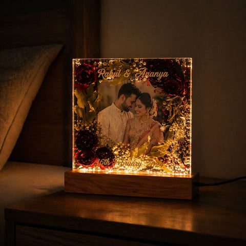 Personalized light box with a couple's photo and names on a wooden base.