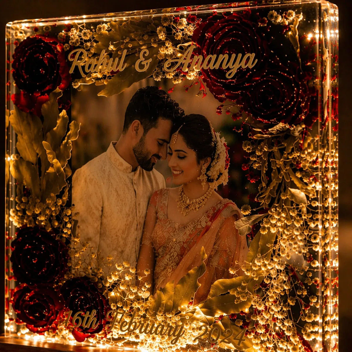 Decorative block with a couple's name and wedding date, surrounded by floral and decorative elements.
