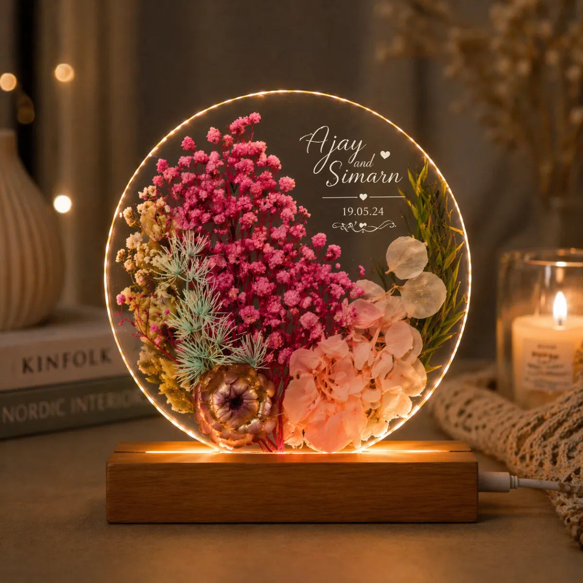 Decorative lamp with flowers and personalized text on a wooden base.