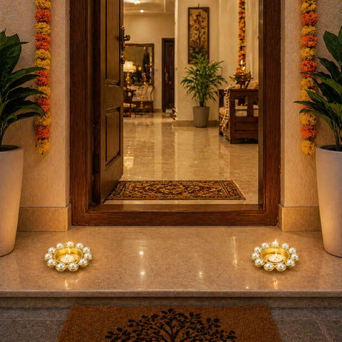 Decorative entrance with floral garlands, candles, and a mirror.