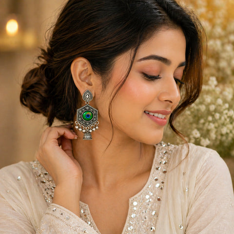 Woman wearing a decorative earring with a blurred floral background