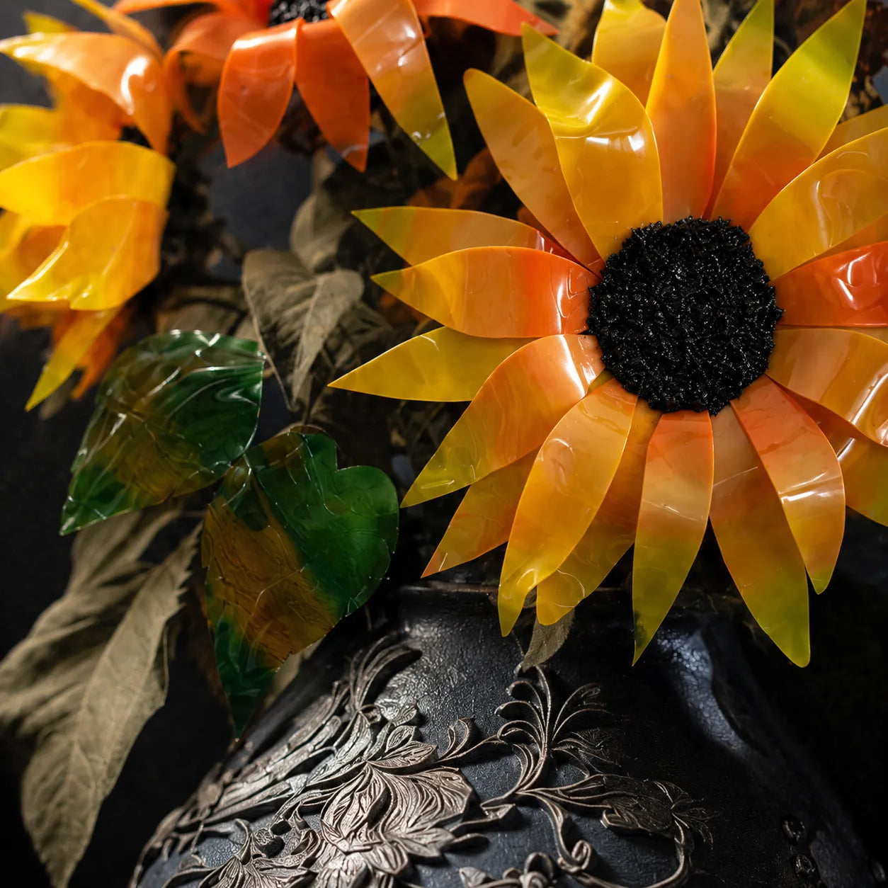 Close-up of decorative sunflowers with a textured surface in the background
