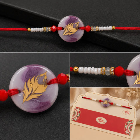 Decorative bracelet with purple bead and gold leaf design on a black background