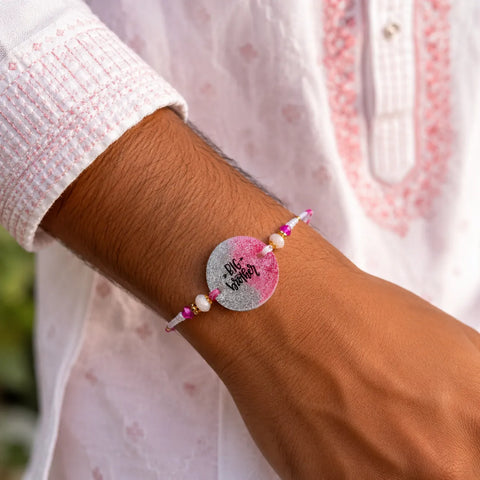 Big Brother glitter resin rakhi tied on brother wrist with festive traditional kurta styling.