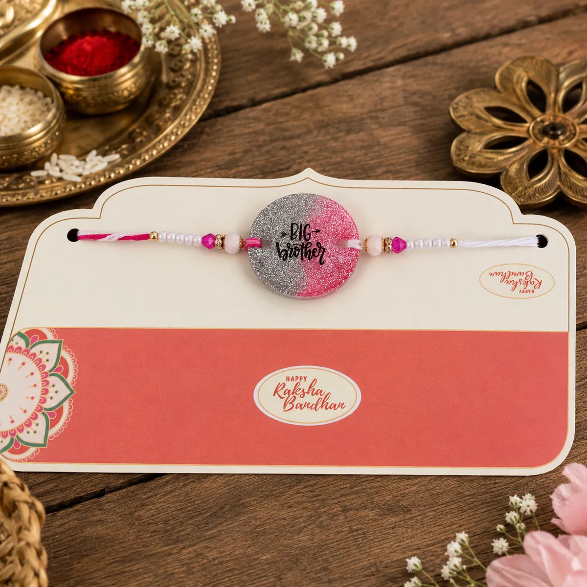 Rakhi on a card with decorative elements on a wooden surface