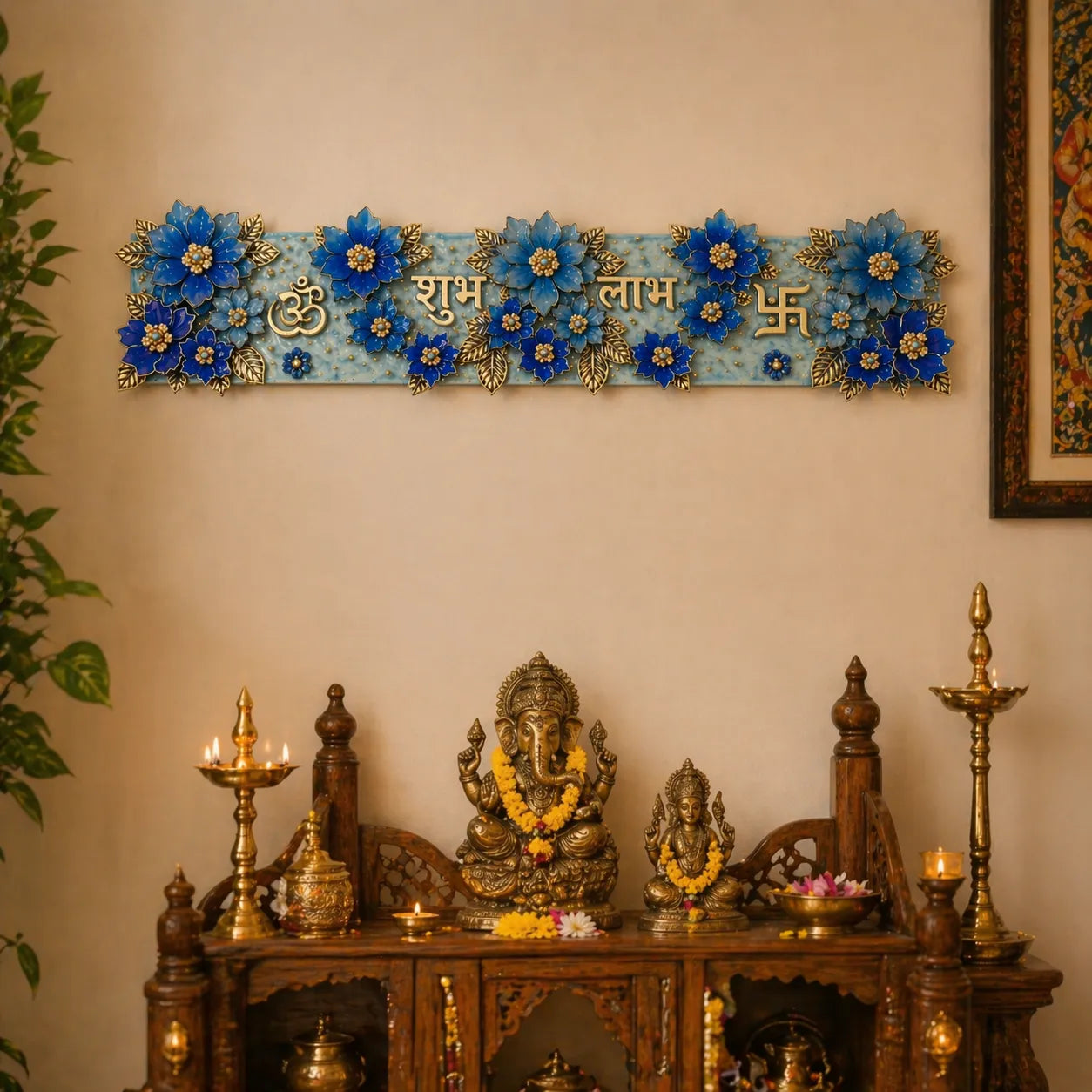 Decorative wall piece with blue flowers and gold accents above a wooden altar with statues and candles.