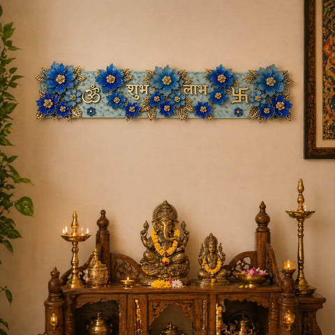 Decorative wall piece with blue flowers and gold accents above a wooden altar with statues and candles.