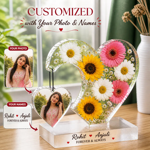 Personalized heart-shaped flower arrangement with customizable photo and names on a wooden surface.