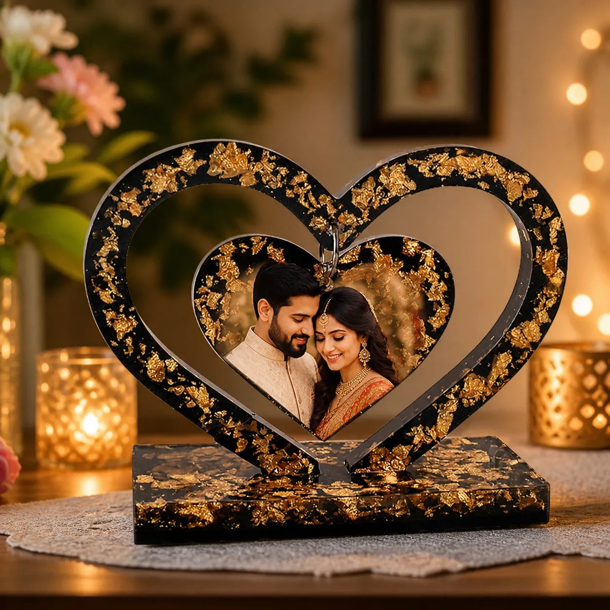 Decorative heart-shaped photo frame with a couple's picture, surrounded by flowers and candles.