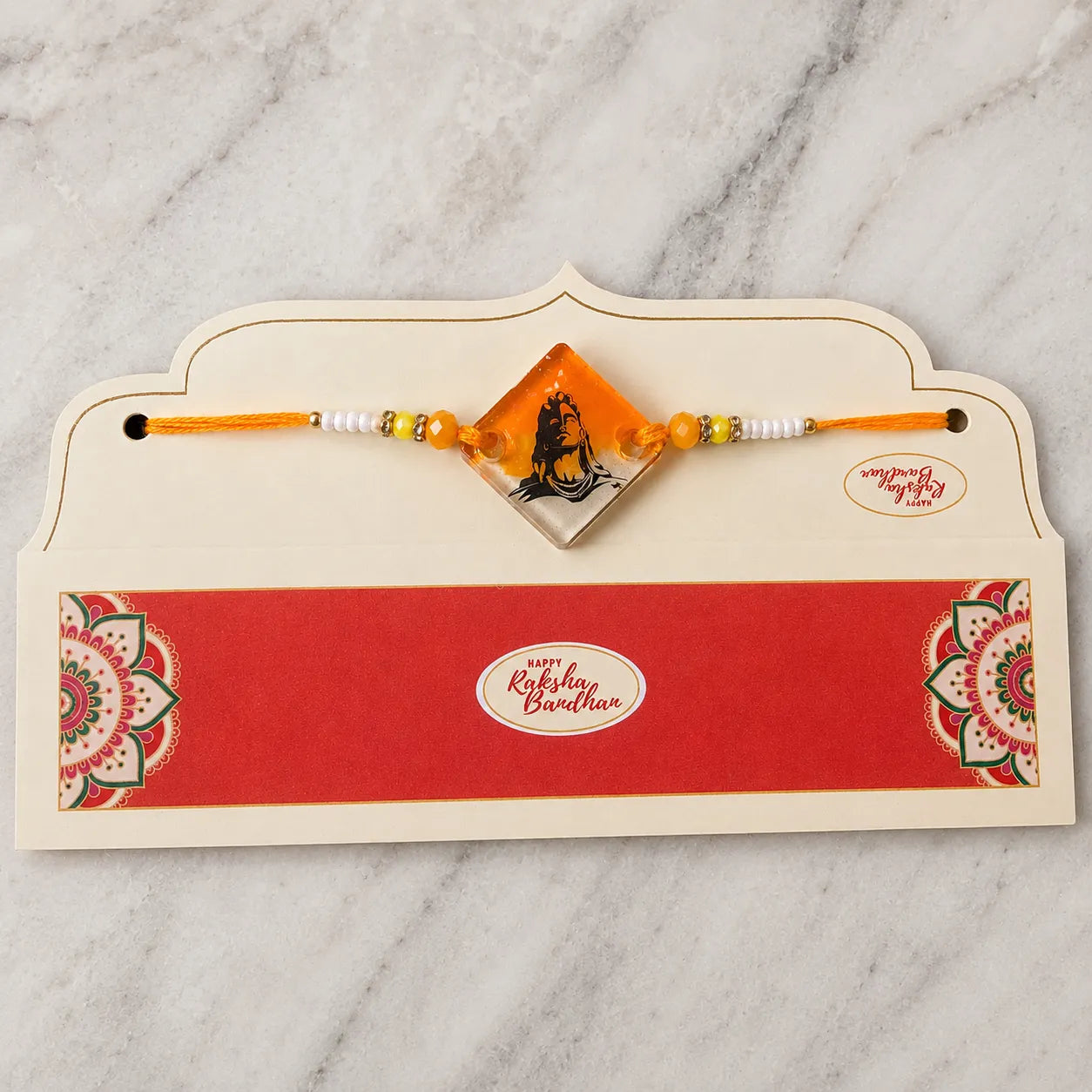 Rakhi with a card on a marble surface