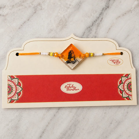 Rakhi with a card on a marble surface