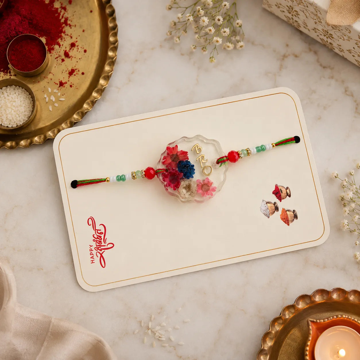 Decorative bracelet with flowers on a card, placed on a marble surface with decorative elements.