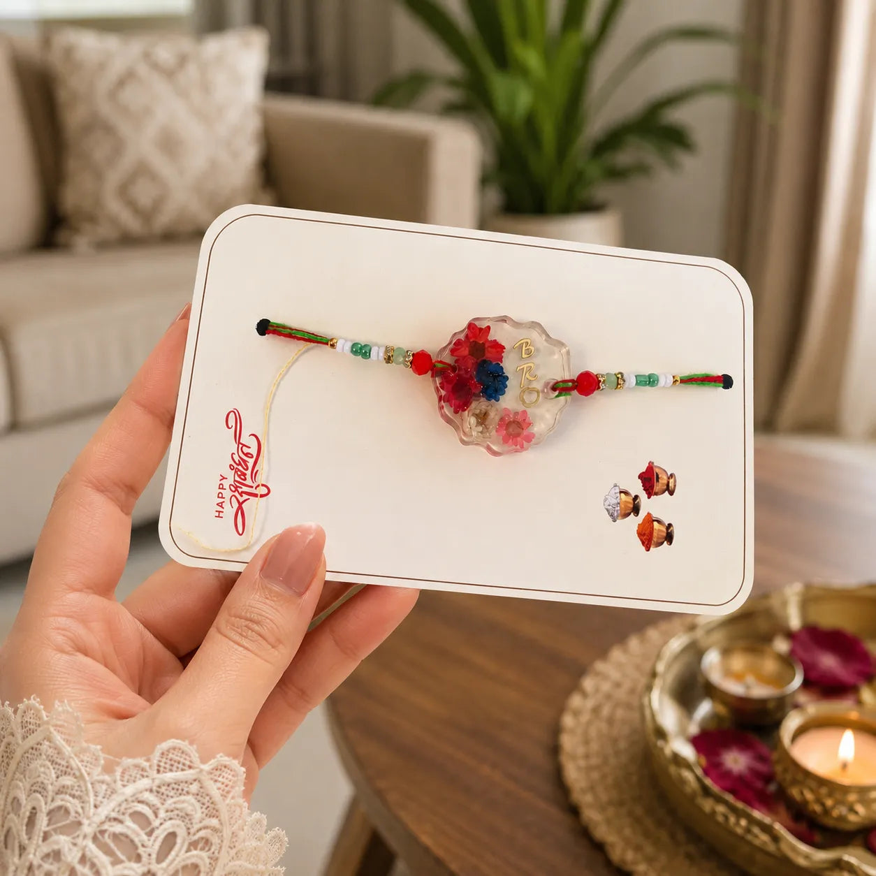 Hand holding a card with decorative items on a blurred indoor background