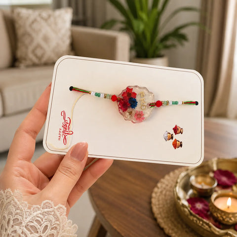 Hand holding a card with decorative items on a blurred indoor background