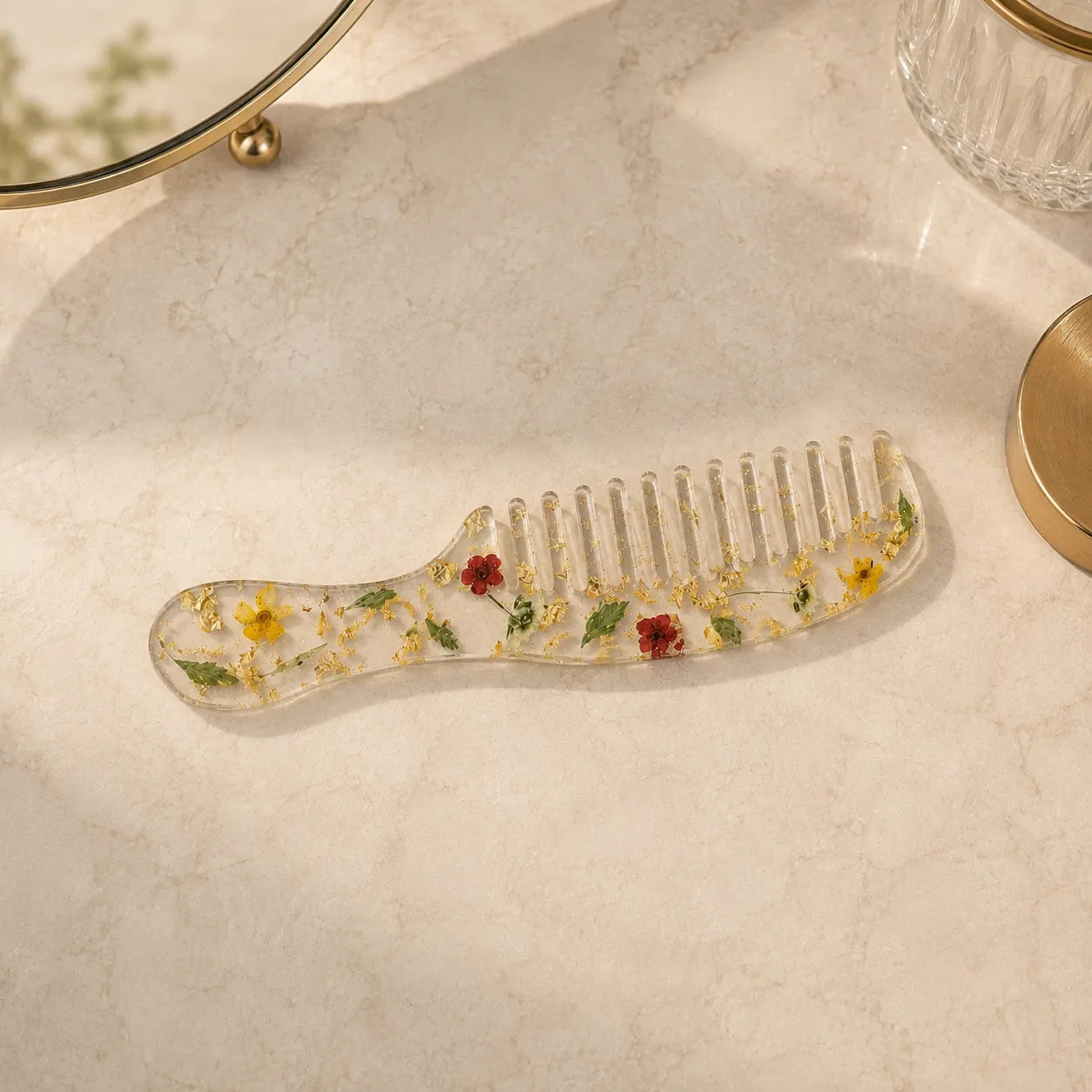 Clear comb with embedded flowers on a light surface