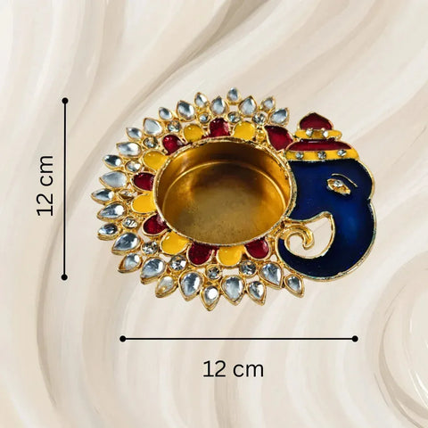 Decorative oil lamp with Ganesha design and measurements on a beige background
