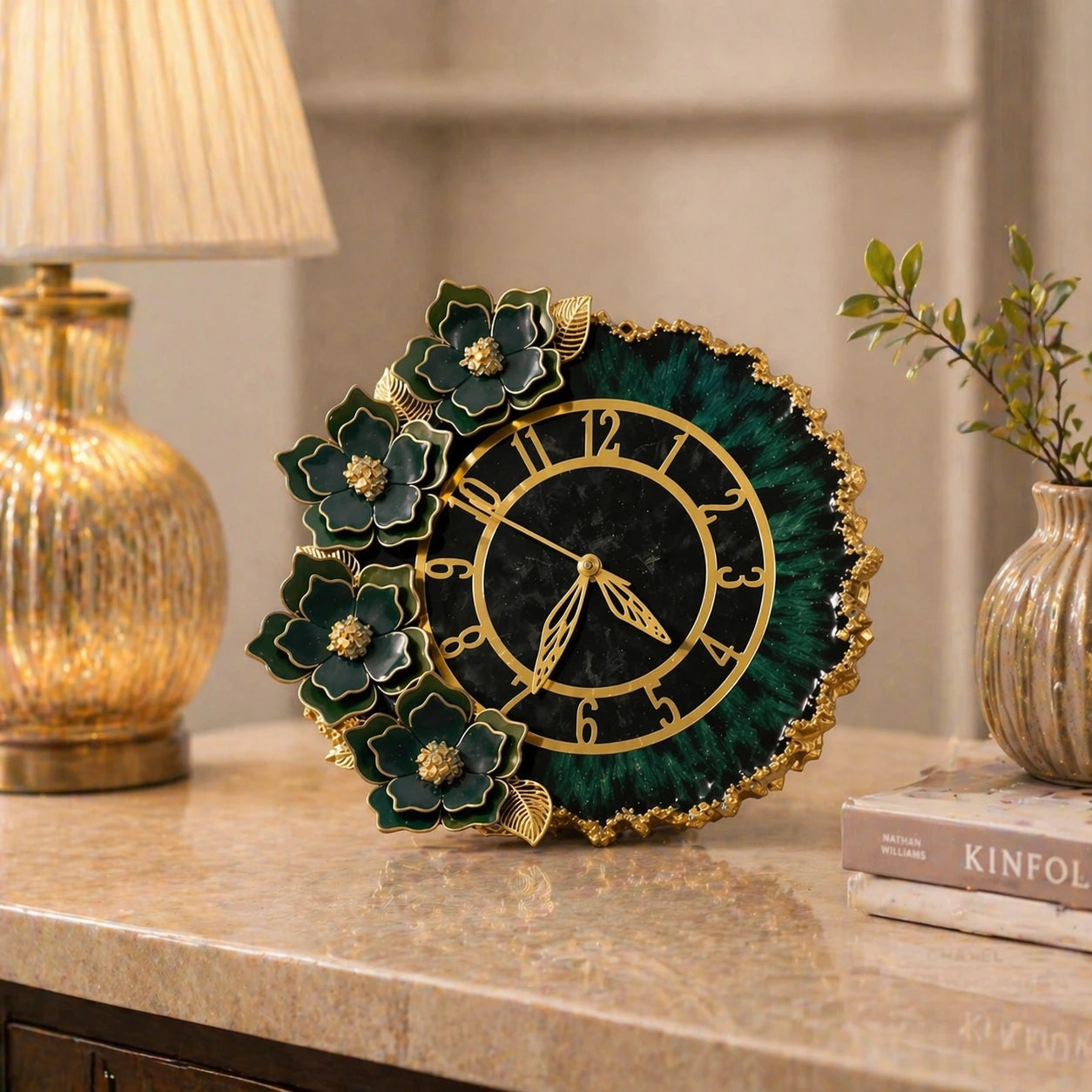 Decorative clock with floral design on a table next to a lamp and books.