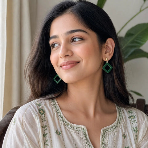 woman wearing green diamond shape drop earrings with gold studs stylish fashion jewellery lifestyle image