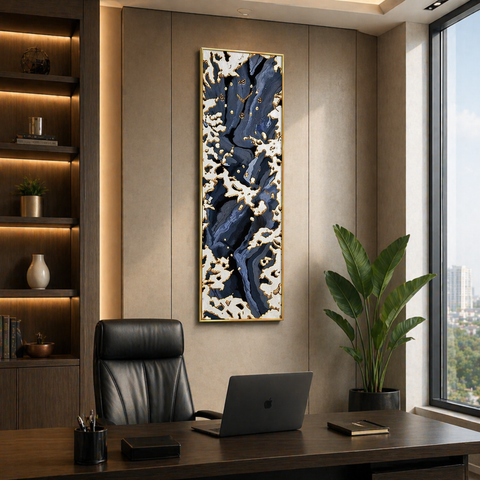 Modern office interior with a desk, chair, laptop, and decorative wall art.
