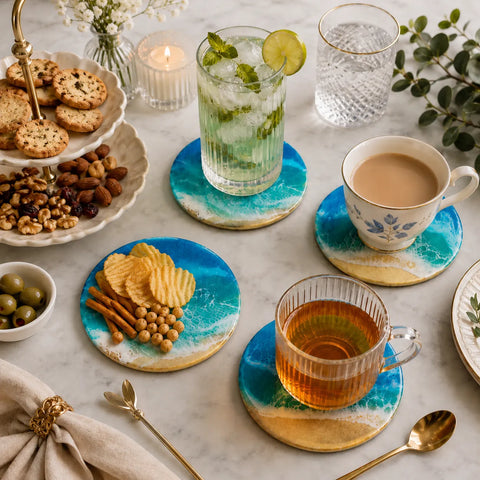 Table setting with tea, snacks, and drinks on decorative coasters.