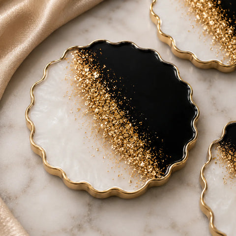 Decorative plates with gold and black gradient on a marble surface