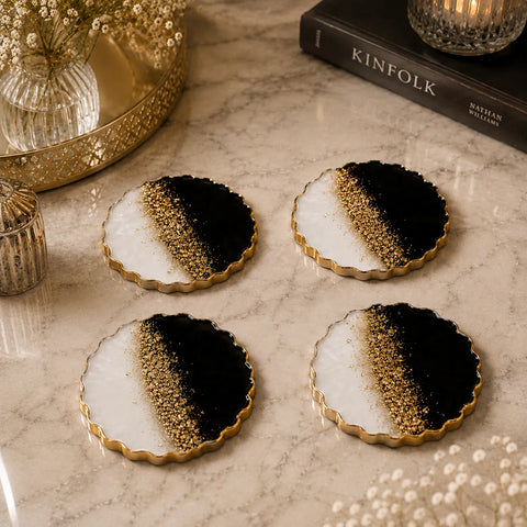 Black and white resin coaster set with gold flakes and glossy finish for luxury table décor.
