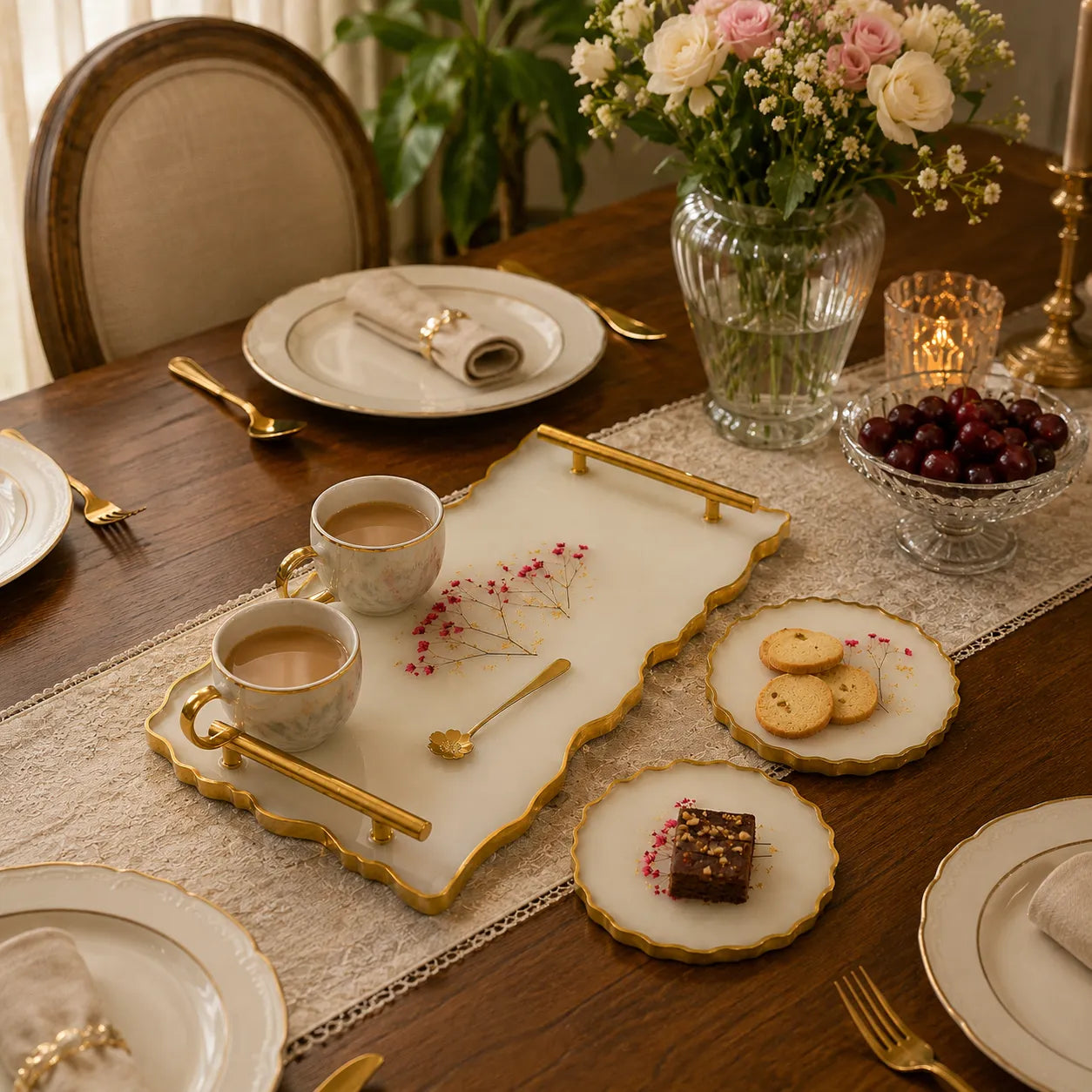 Elegant dining table setting with coffee, pastries, and flowers.