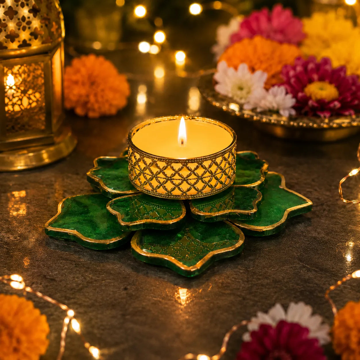 Decorative candle holder with a lit candle on a dark surface with flowers and lanterns in the background.