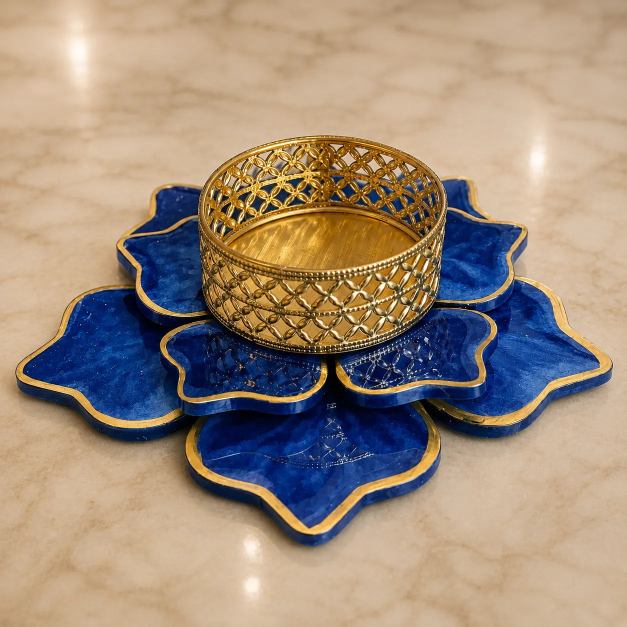 Decorative blue and gold dish on a beige marble surface