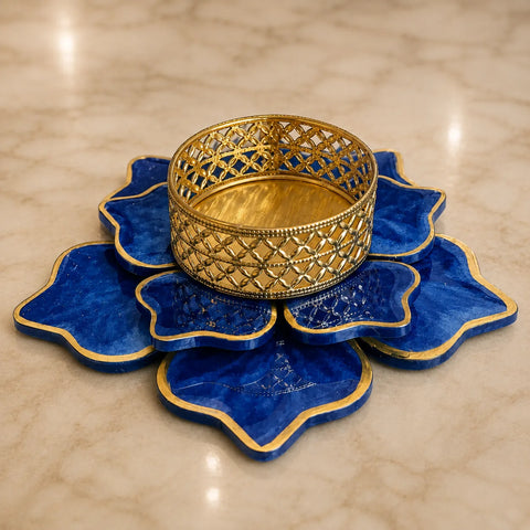 Decorative blue and gold dish on a beige marble surface