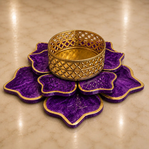 Decorative purple and gold bowl on a beige surface