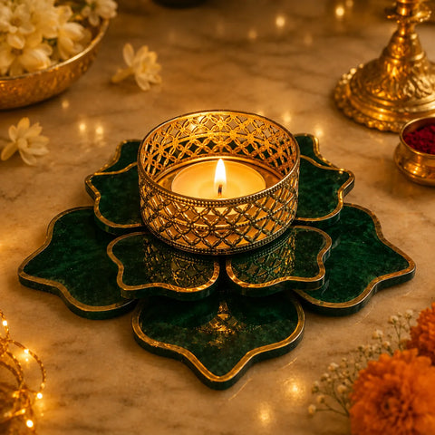 Decorative candle holder with a lit candle on a decorative surface with flowers and lights.