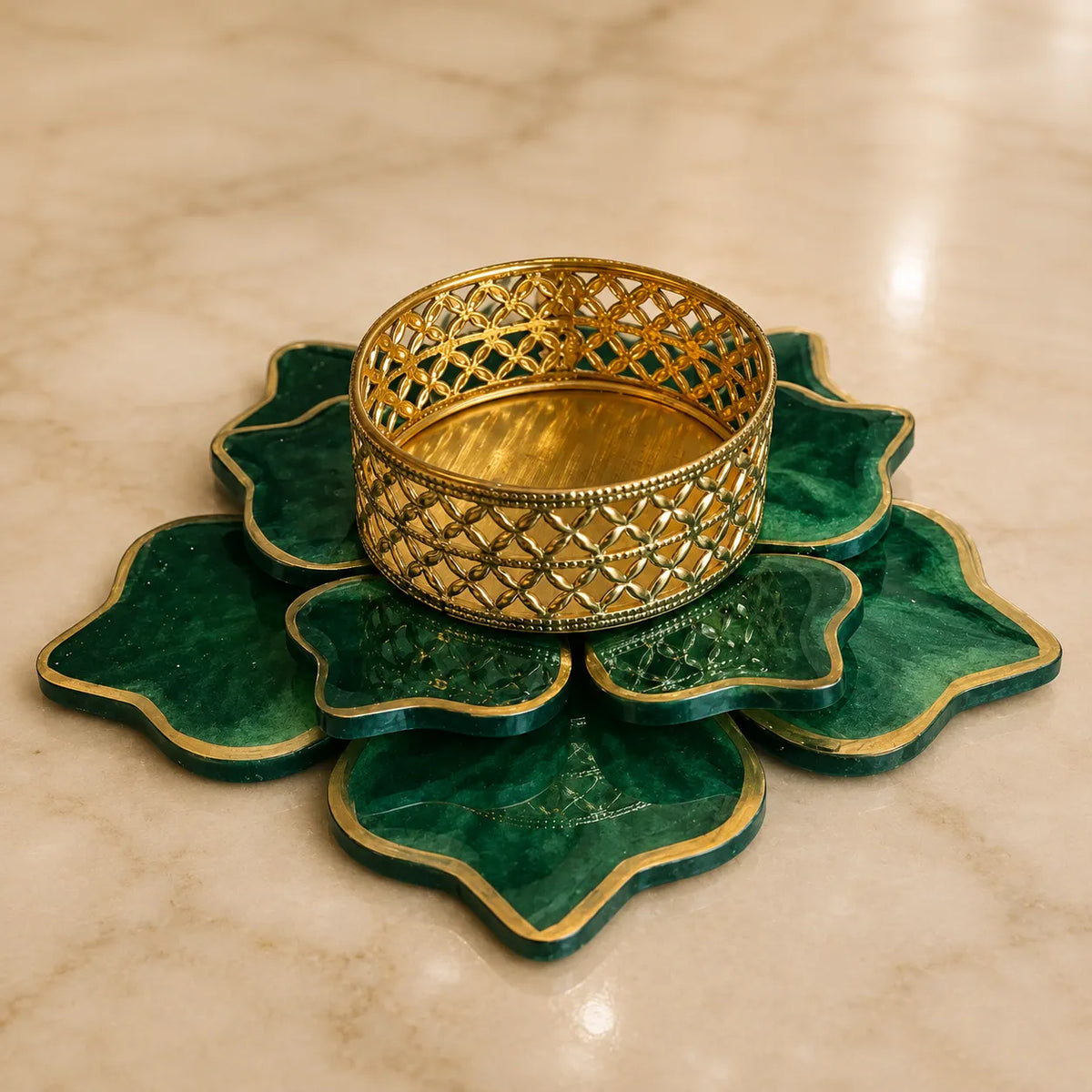 Decorative gold bangle on a green lotus-shaped stand against a beige marble background