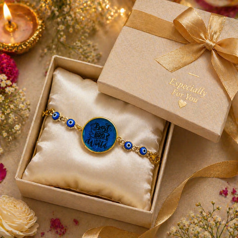 Bracelet with blue evil eye design in a gift box with a gold bow, surrounded by flowers and candles.