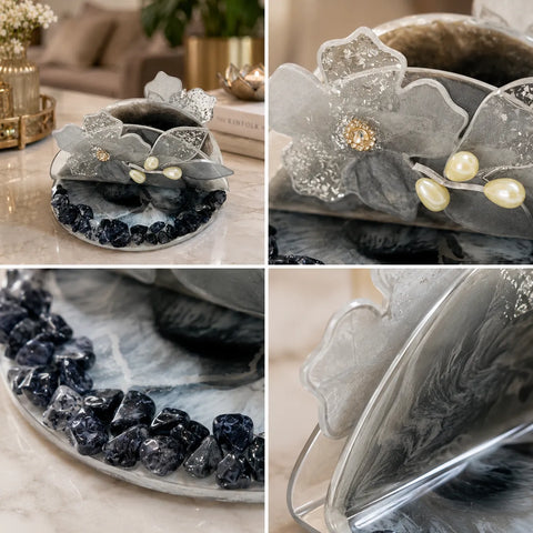 Decorative item with floral design and gemstones on a marble surface.